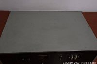 Top view of the Warfdale Subbass 2130 subwoofer showing light surface wear and dust
