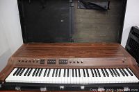 Full view of Yamaha CP-30 keyboard open in case, showing woodgrain finish and full keybed
