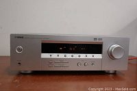 Front view of Yamaha HTR-5920 AV Receiver showing the unit powered on with display and control buttons visible.