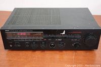 Front view of the Yamaha RX-500U stereo receiver showing power, LED display indicating AM frequency 840, headphone jack, speaker selection, and bass/treble controls.