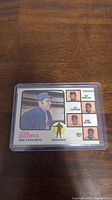 Front view of 1973 Topps Yogi Berra baseball card in protective case showing image and text.