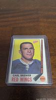 Front of 1969-70 Topps Carl Brewer hockey card showing player's portrait, team, and position.