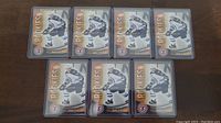 Seven Mark Scheifele rookie hockey cards in individual protective plastic holders displayed on a wooden surface.