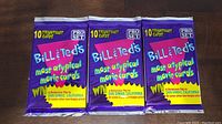 Three sealed packs of Bill & Ted's Most Atypical Movie Cards laid side by side on a wooden surface.