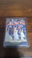 Front of the Connor McDavid rookie card showing him in Edmonton Oilers uniform celebrating on ice.