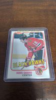 Front of Denis Savard rookie card with Black Hawks uniform and 'ROOKIE CARD' header.