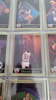 Close-up of basketball trading cards featuring Michael Jordan dunking, Bill Cartwright playing defense, and others from Chicago Bulls and Celtics.