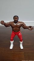 Front view of the LJN Junkyard Dog wrestling figure showing muscular chest, facial details, red pants and white boots.
