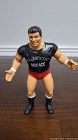 Front view of the LJN Magnificent Don Muraco wrestling action figure with black shirt, red trunks, and black boots.