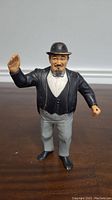 Front view of LJN Mr. Fuji wrestling figurine with painted details and raised right arm.