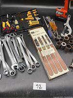 Wide view showing combination wrenches, drill, screwdrivers, lock breaker, sockets, and wood turning chisel set in box.