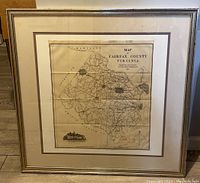 Frontal view of framed map showing the whole Fairfax County area in 1907 with detailed roads, borders, and inscriptions.