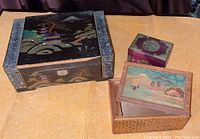 Photo of three vintage wood boxes including large painted music box and two smaller painted decorative boxes