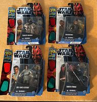 Photo shows all four new Star Wars 3-D action figures in original sealed blister packs: Tusken Raider, Mawhonic, Obi-Wan Kenobi, and Darth Maul, along with the included 3-D glasses for viewing effects.