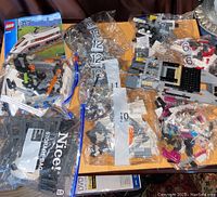 LEGO City Supersonic Train 60051 instruction manual, numerous numbered bags of parts, and electronic controller.