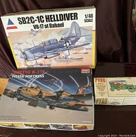 Three vintage unassembled model kits: SB2C-1C Helldiver VB-17 at Rabaul, Boeing B-17F Flying Fortress, and Pyro 1911 Stevens-Duryea Tourer car kit.