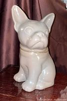 Front angle photo of the ceramic dog-shaped cookie jar showing the full figure and details of the face and ears