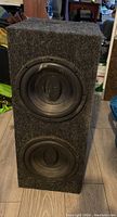 Full view of the vintage double Memphis speaker box showing two black Memphis speakers mounted in a vertical arrangement inside a carpeted box.