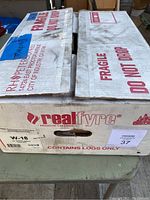 Closed box showing branding and lot details on packaging with 'Realfyre' and 'RH Peterson' labels.