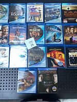 Blu-Ray collection showing multiple titles including Roving Mars, Deja Vu, The Waterboy, Swing Vote, and more. Most discs sealed in blue Blu-Ray cases.