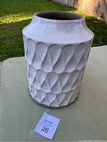 Front angle view of the white Kora vase showing the textured geometric pattern and shape.