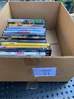 Box containing a set of DVD cases, arranged upright showing spines and some front covers visible.