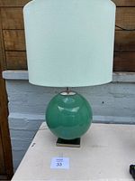 Full view of Kate Spade Elsie table lamp showing the green spherical base and white drum shade.