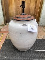 Full view of Pottery Barn Courtney white ceramic table lamp, showing base and top, switched off.