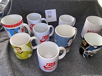 Eight Star Trek-themed mugs arranged on carpet