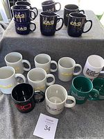 Full view of all 14 mugs including multiple color variations and logos
