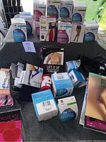 Photo of assorted new boxed women's pantyhose and bra, showing branding and various styles