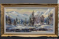 Front view of the framed oil painting showing the full winter landscape scene, mountains, pine trees, and river with snow.