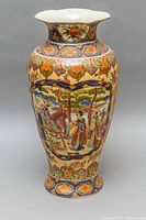 Front view showing full vase with detailed hand-painted Japanese scene including people, horse, and nature elements.