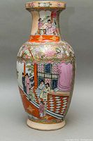 Front view of the tall ceramic vase showing detailed Japanese scene and floral designs.