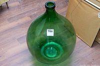 Large green glass terrarium viewed from top angle showing narrow opening.