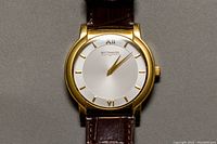 Front view of watch face showing gold-tone case, silver dial, Wittnauer logo, gold-tone hour markers and hands