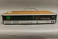 Front view of the full stereo receiver with wood panel on top and front controls, showing the unit's overall condition and style.