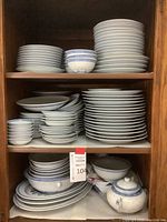 Shelving unit with stacks of plates and bowls