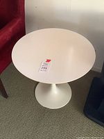 Full view of round off-white tabletop and base