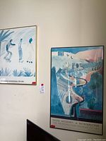 Both framed prints hung side by side against wall