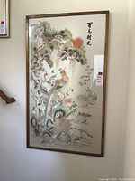 Full view of framed embroidered silk artwork on wall
