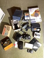 Overview of all items laid out including cameras, loaders, paper, chargers and accessories