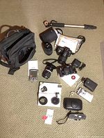 Overall layout showing cameras, bag, monopod, lenses, cases, digital camera, PDA and filter adapter ring