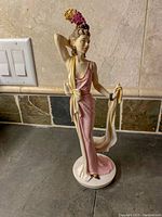 Front view of the Christina figurine showing detailed dress, headdress, and pose