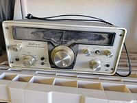 Front view of Allied AX-190 communications receiver showing tuning and control knobs, frequency scale, and headphone jack with dust on surface.
