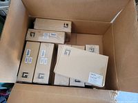 Open cardboard box showing multiple sealed Level One branded boxes of networking equipment.