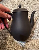 Photo of Wedgwood Black Basalt matte black tea/coffee pot approx. 6.5 inches high, held for scale