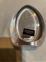 Base view showing Wedgwood England label sticker on clear glass paperweight.