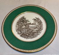 Top view of the Wedgwood commemorative plate showing detailed illustration and gold rim