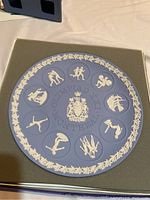 Wedgwood blue jasper plate with white jasper Olympic sport bas reliefs and laurel border, commemorating 1976 Montreal Olympics.